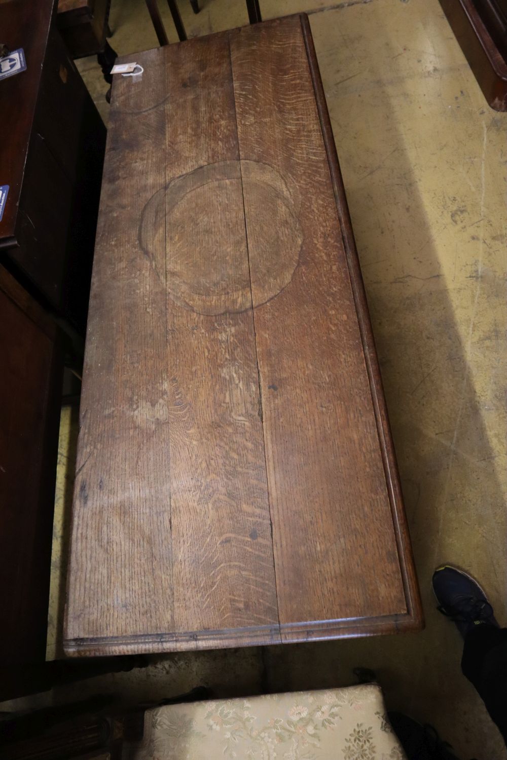 A 17th/18th century inlaid oak coffer with panelled front and planked top, width 145cm depth 53cm height 66cm